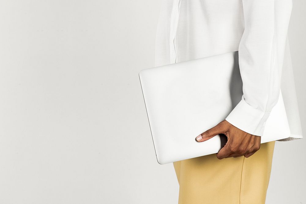 Black woman holding a laptop 