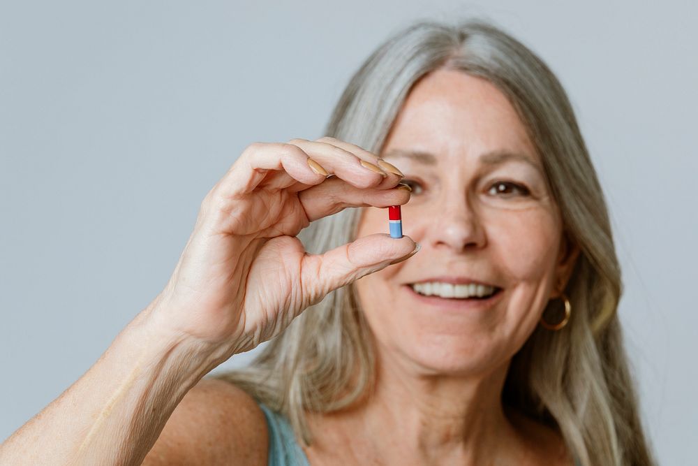 Senior taking a pill for viral disease