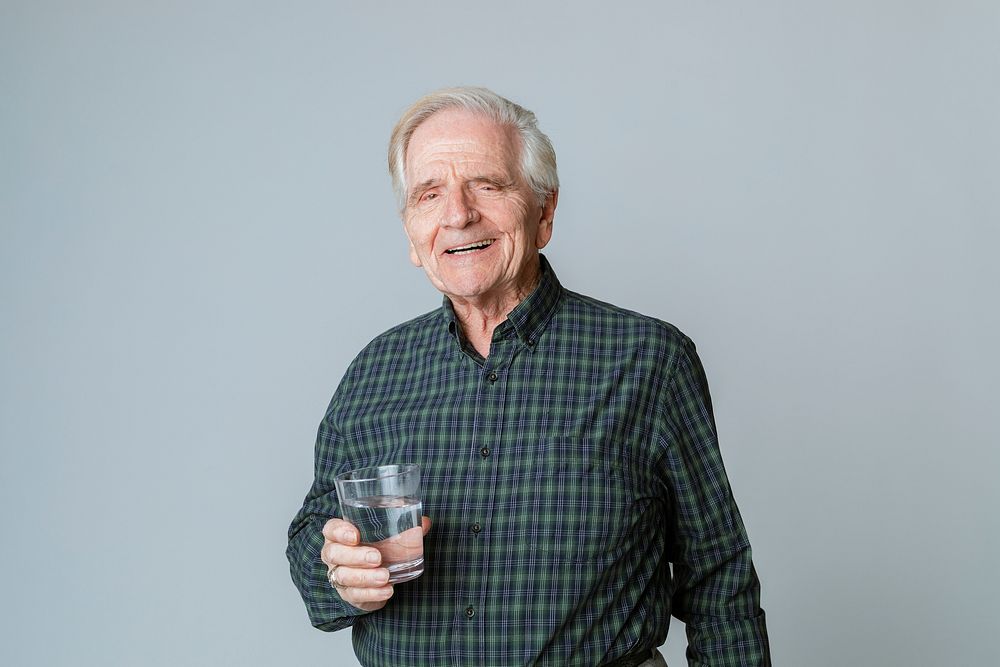 Senior man with a glass of water