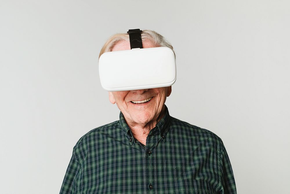 Cheerful senior man wearing virtual reality headset