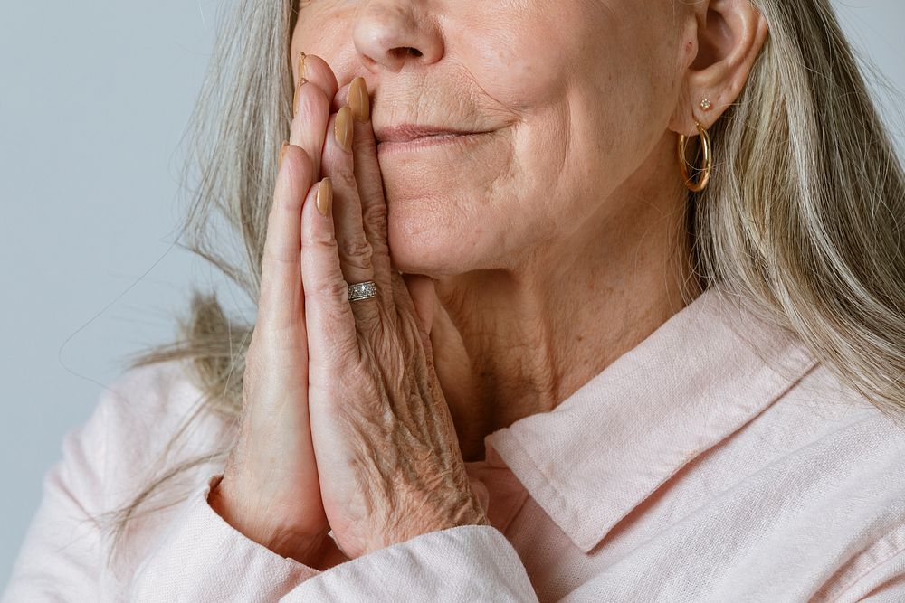 Close up of senior woman praying