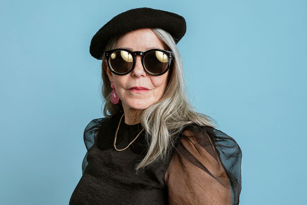 Cool grandma with an attitude in a beret and sunglasses