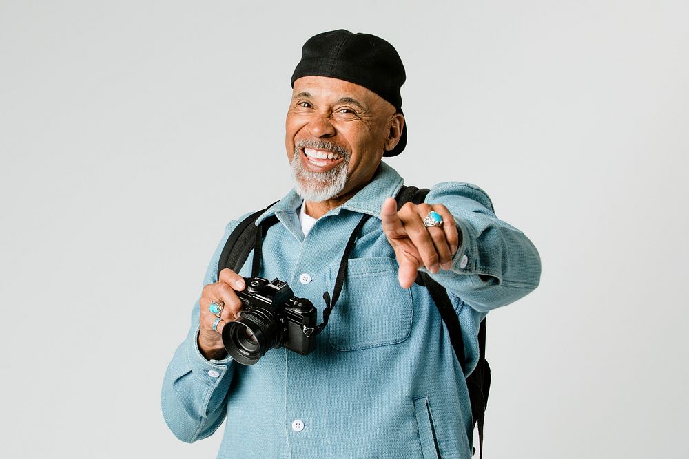Happy senior man with a digital camera