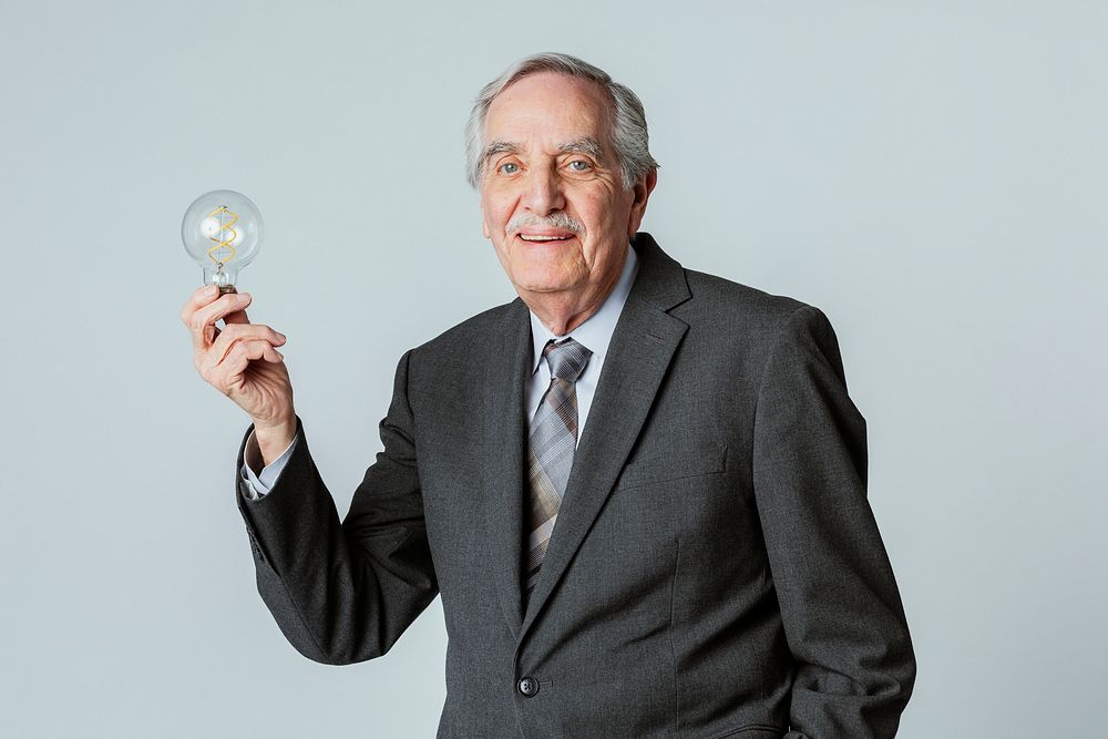 Happy senior businessman with a light bulb