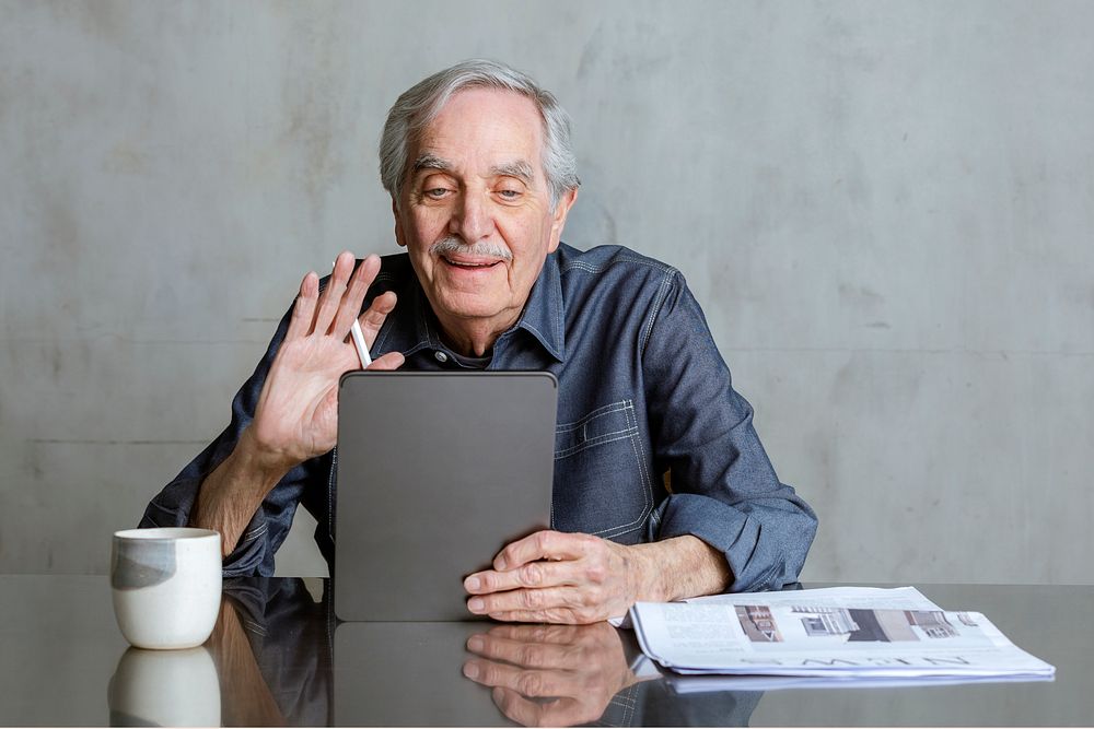 Senior man making video call from tablet computer during coronavirus pandemic