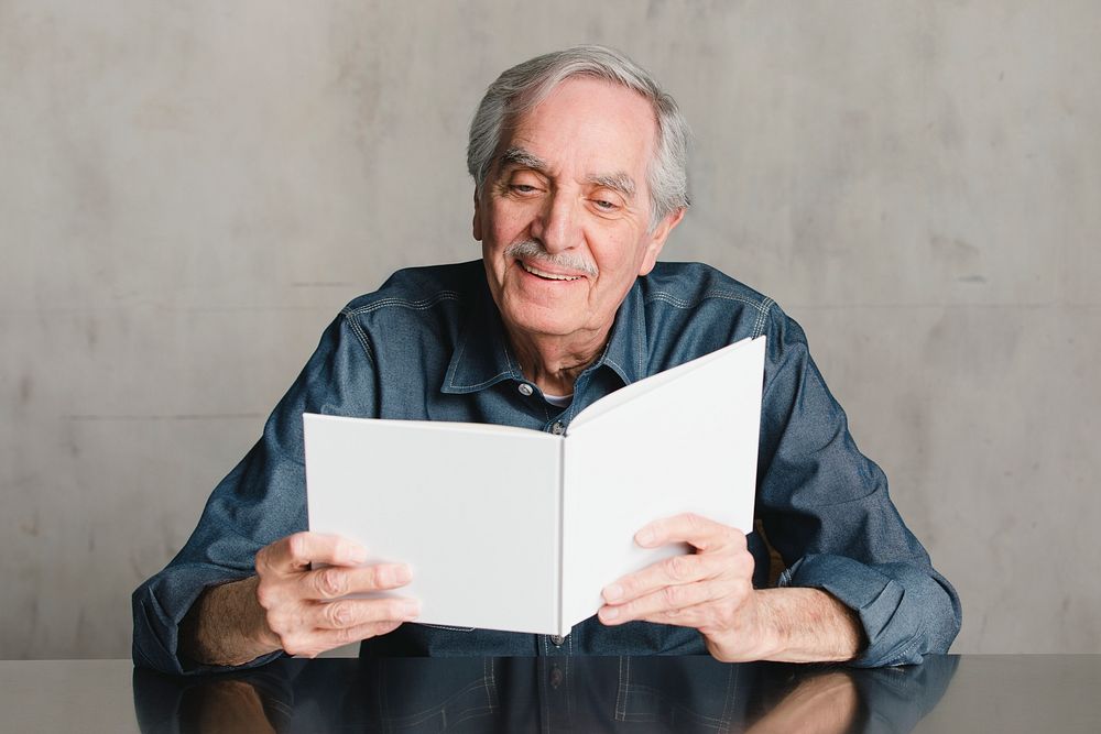 Happy senior man reading a book