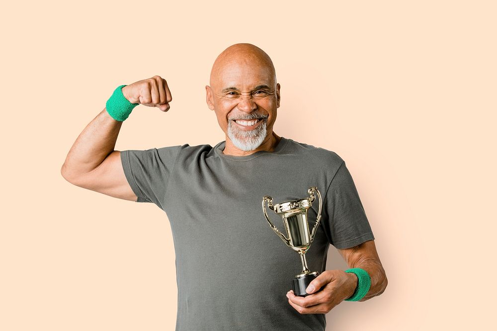 Happy senior man holding a trophy cup mockup