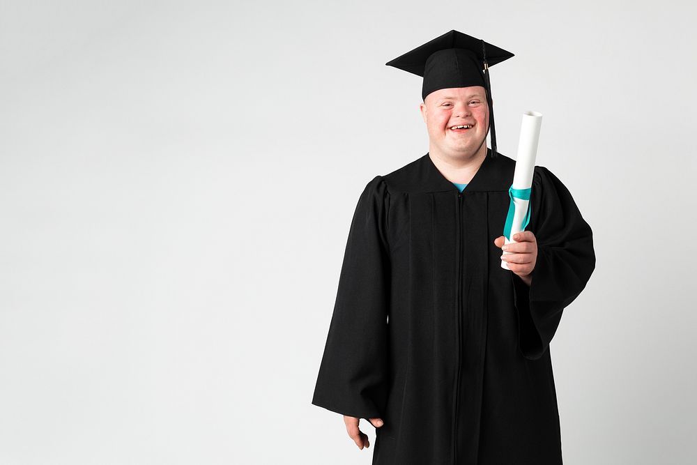 Cute boy with down syndrome in a graduation gown 