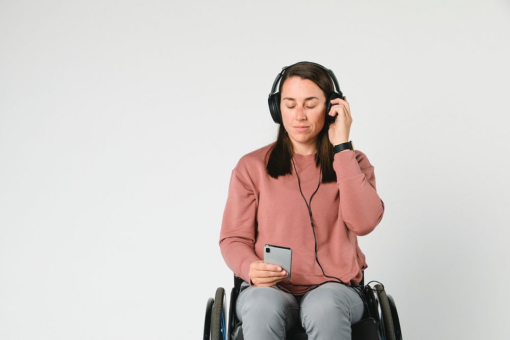 Cool woman in a wheelchair listening to music