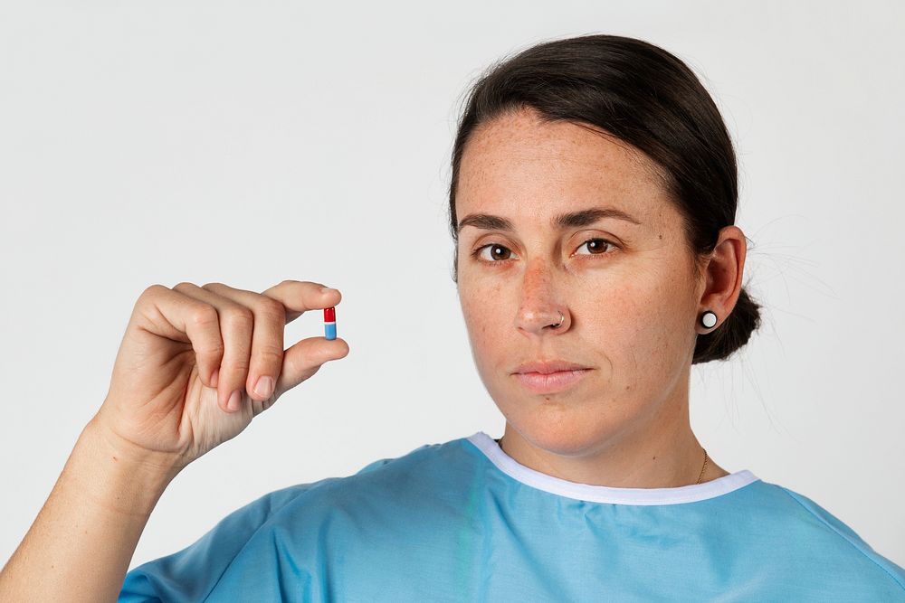 Patient holding a red and blue pill