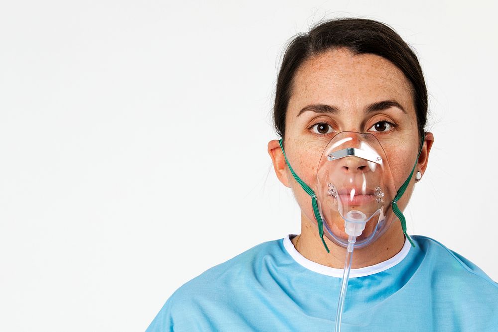 Sick female patient with an oxygen mask