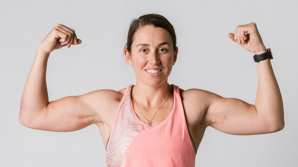 Female athlete flexing her arms 