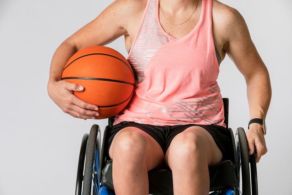 Female athlete in a wheelchair holding a basketball