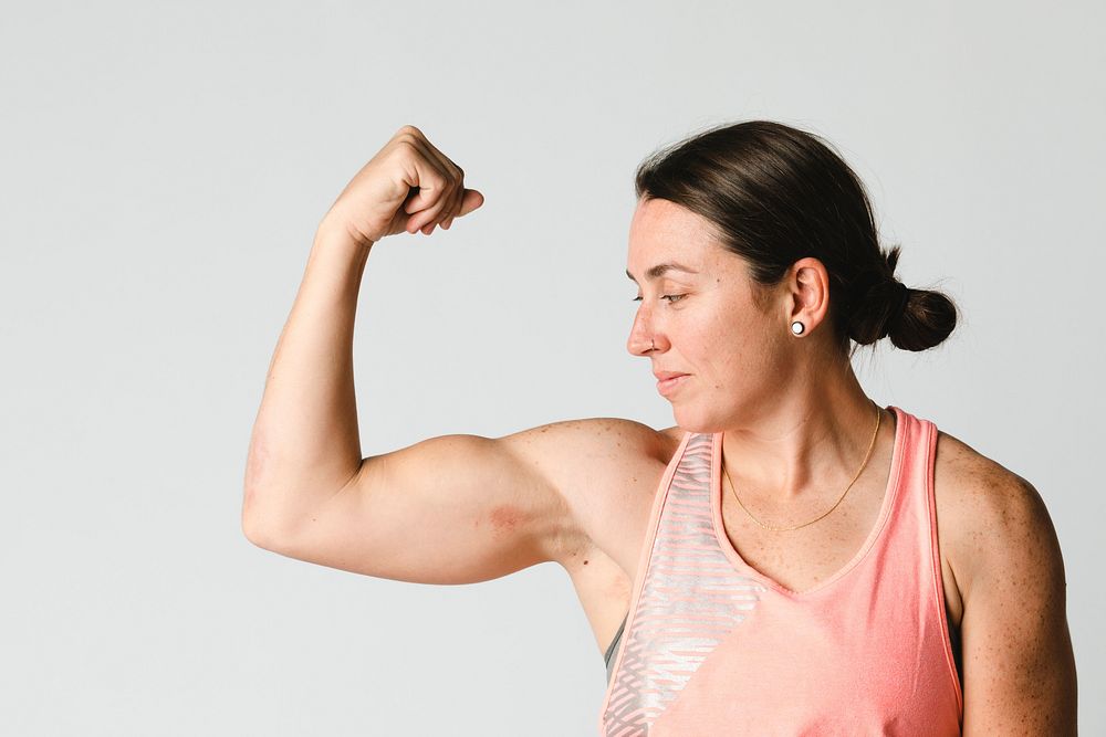 Female athlete flexing her arms 