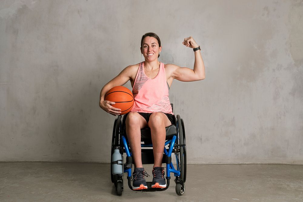 Basketballer in a wheelchair flexing her arms