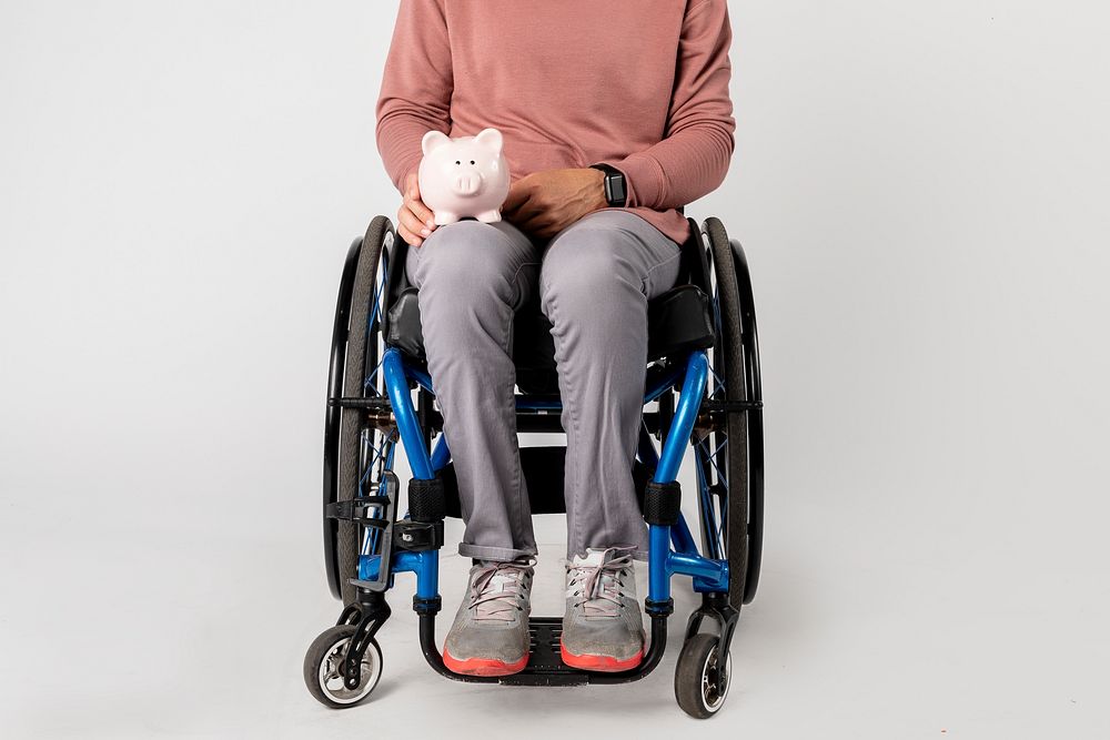 Woman in a wheelchair with a piggy bank