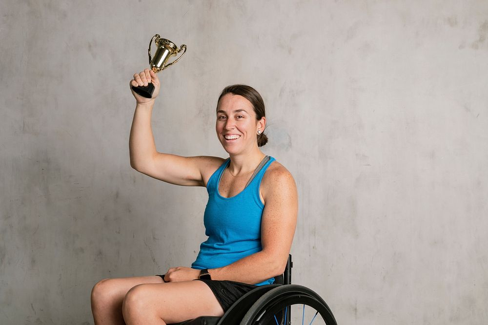 Female athlete in a wheelchair with a trophy 