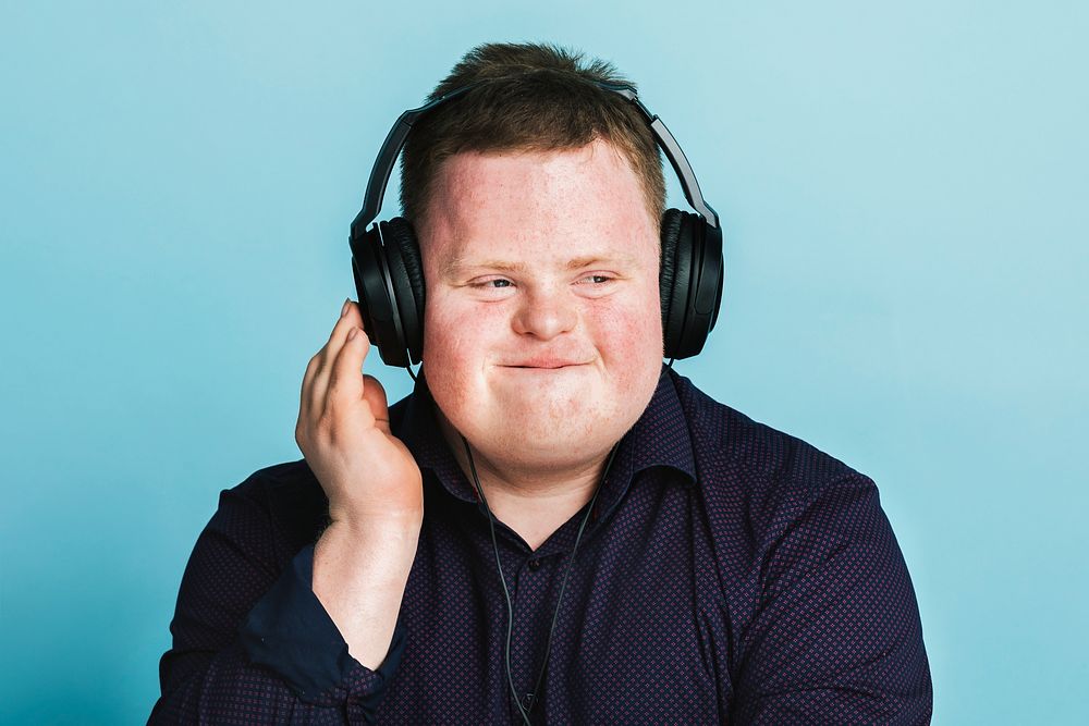 Cool young man with Down Syndrome listening to a sport podcast