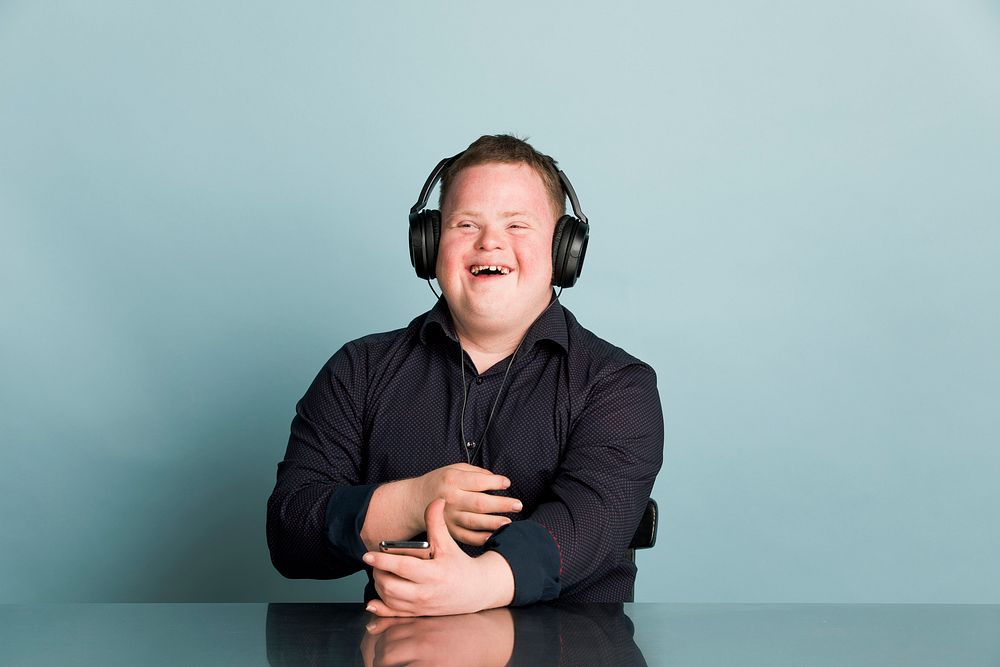 Cool young man with Down Syndrome listening to a sport podcast