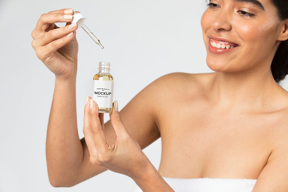 Young woman using a bottle dropper mockup 