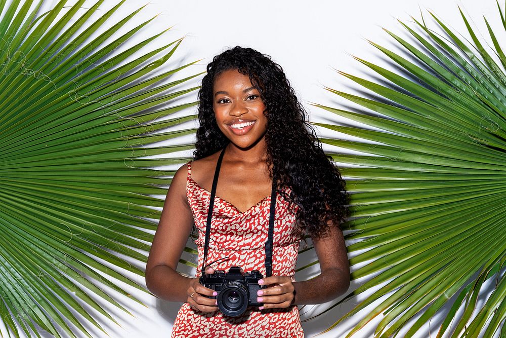 Beautiful black woman with an analog camera