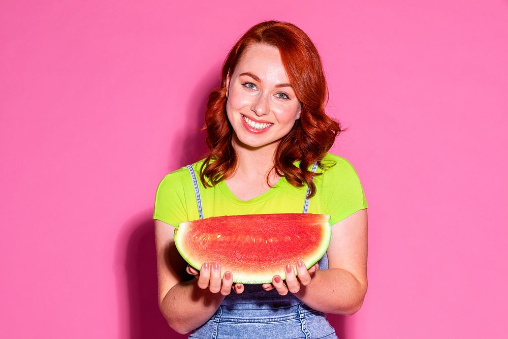 Happy woman holding a slice of watermelon 