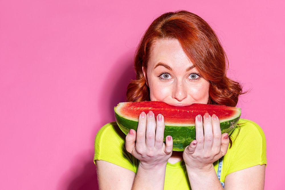 Woman biting into a slice of watermelon