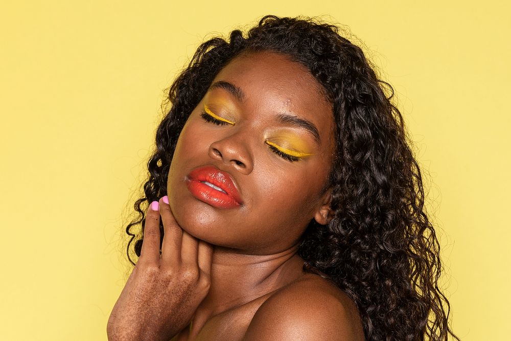 Sensual black woman wearing a peach lip gloss