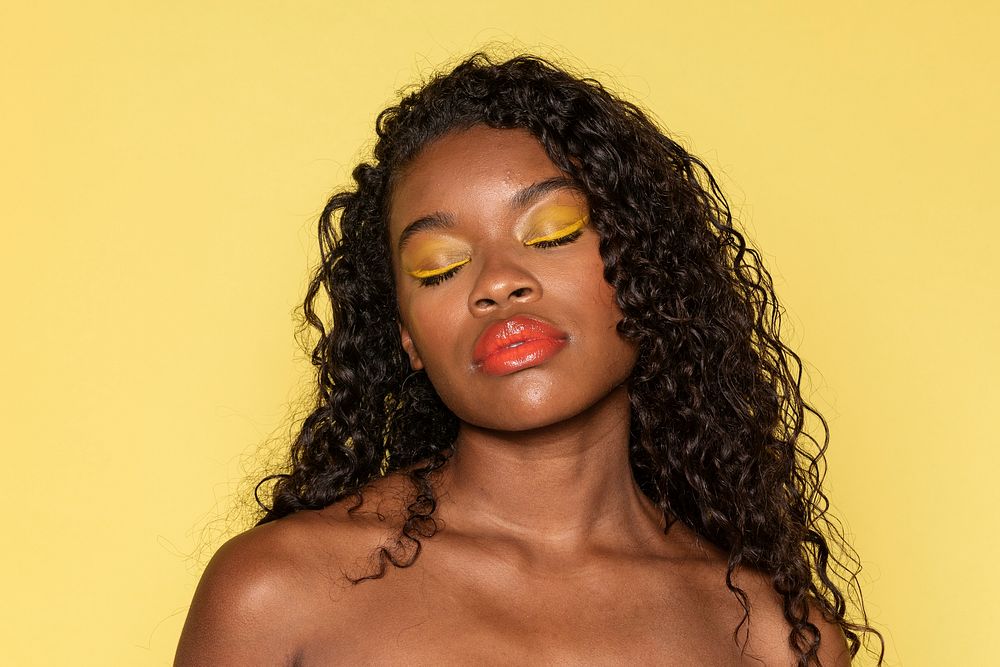 Sensual black woman wearing a peach lip gloss