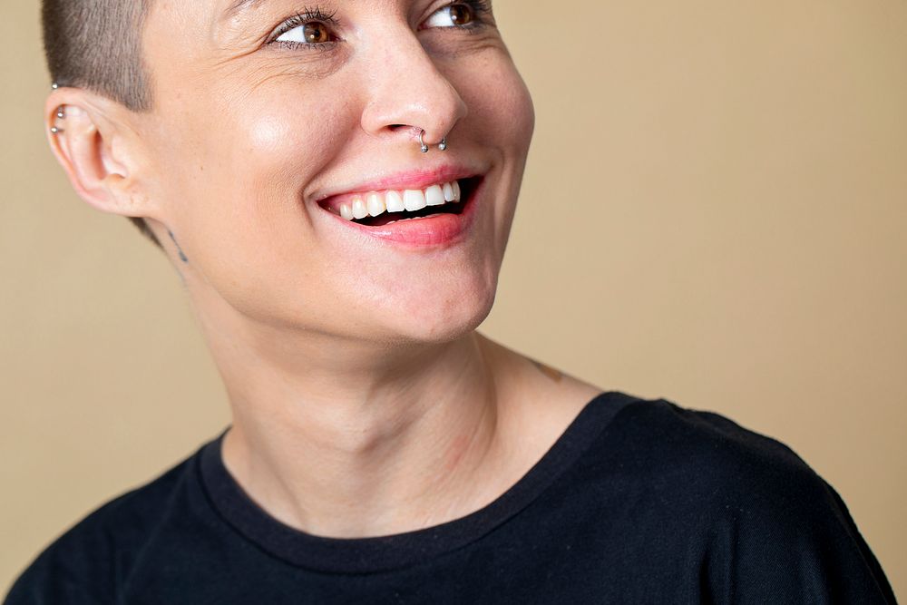 Happy skinhead woman smiling in studio shoot