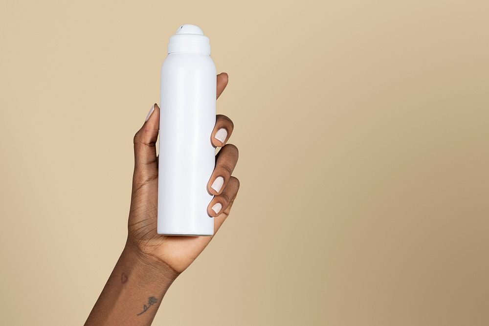 Black woman holding a white spray bottle