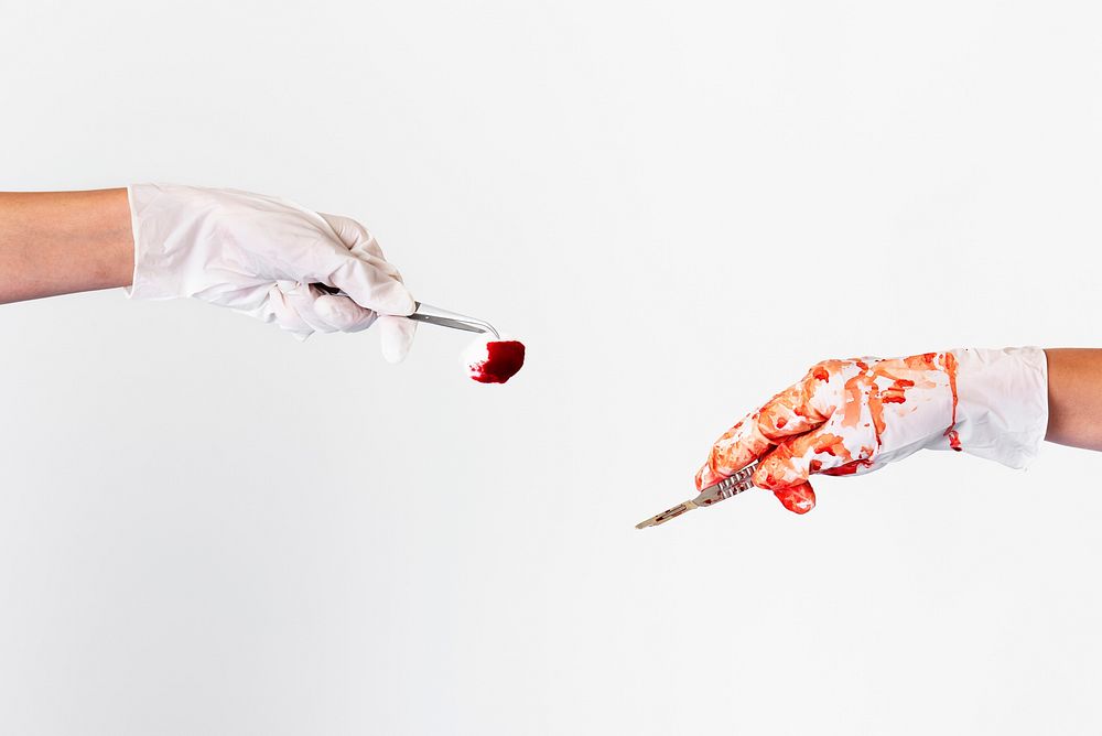 Hands holding a scalpel and a bloody cotton ball