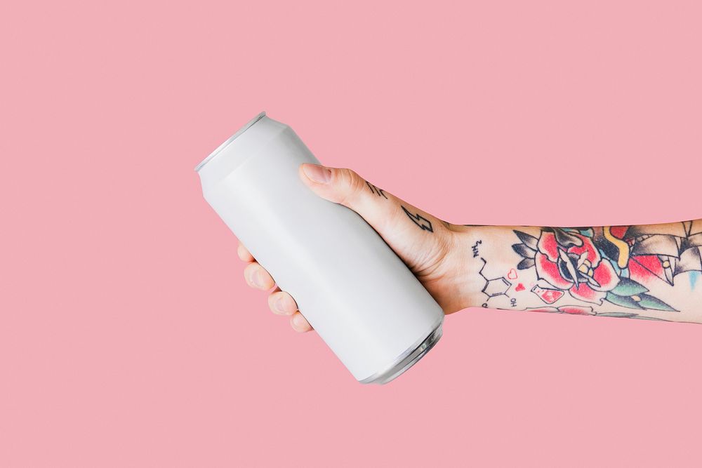 Hand holding a white aluminum can