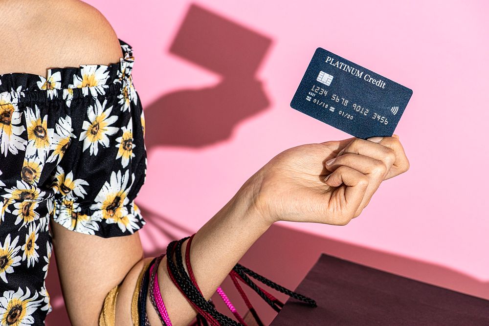 Woman holding a credit card and shopping bags