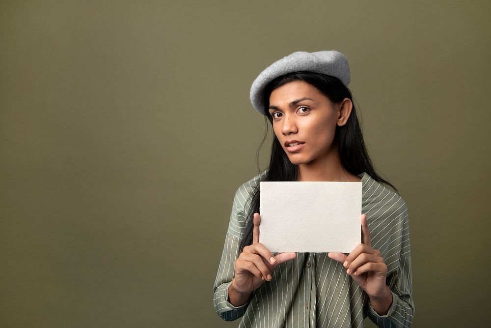 Transgender woman showing a blank white card with design space