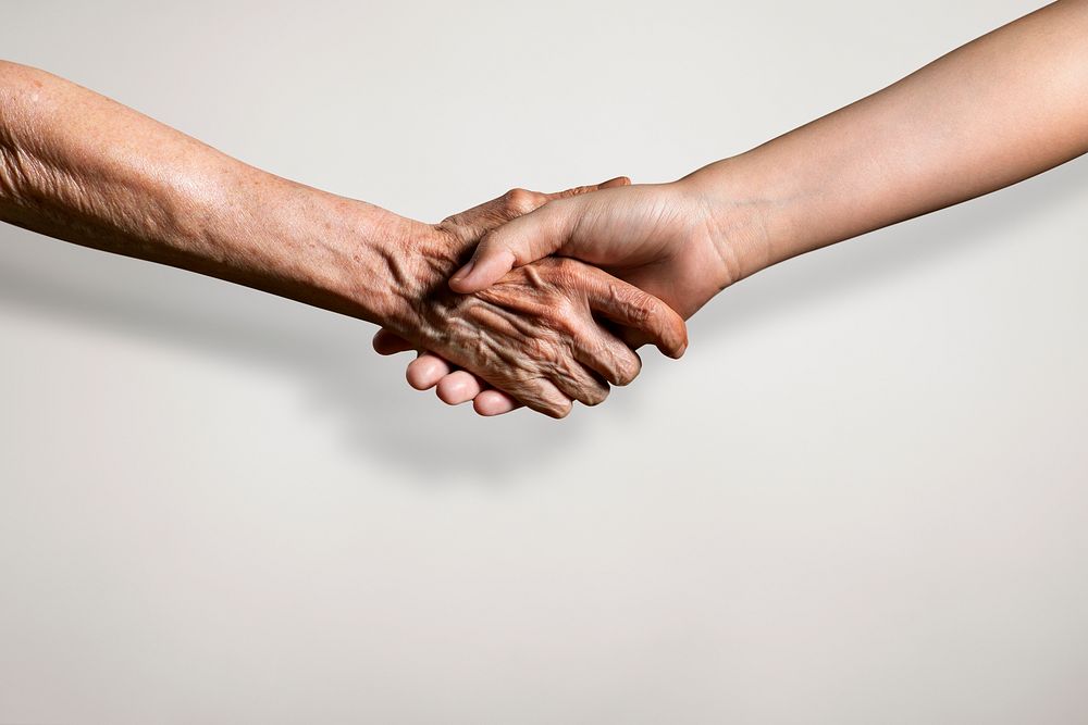Two person from different generation shaking hands in an agreement mockup