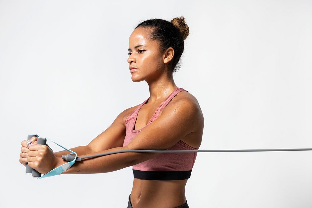 Black woman using resistance band for workout