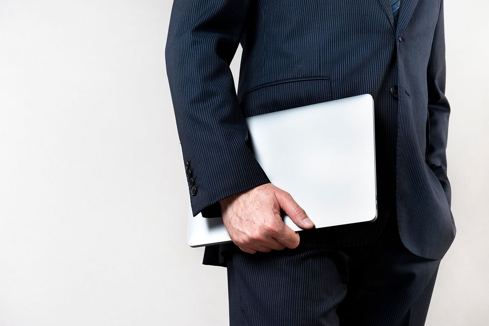 Businessman carrying a laptop