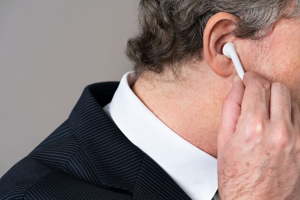 Businessman wearing wireless earphones