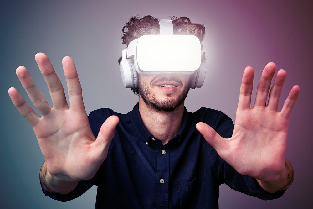 Young man using a VR headset in a two tone background