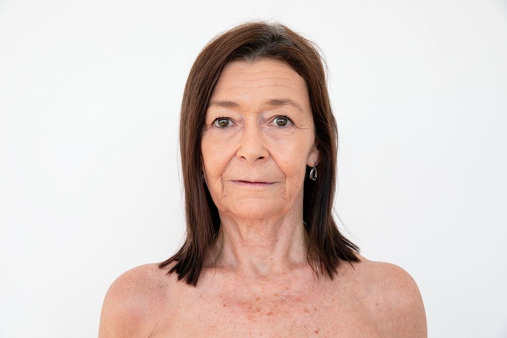 Nude senior woman with a neutral facial expression 