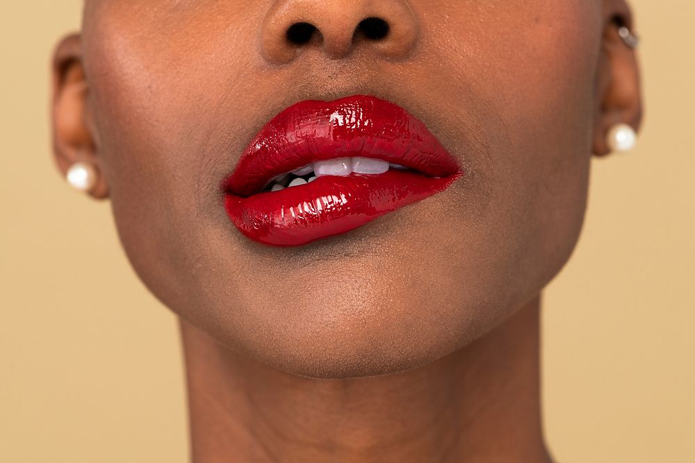 Black woman biting her red lips 