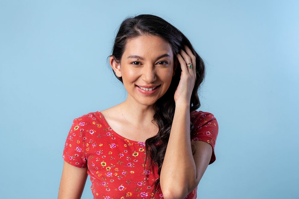 Cheerful Asian woman isolated on blue background
