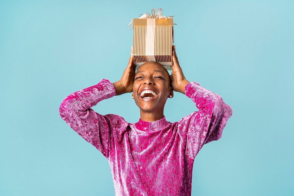 Happy black woman holding a gift box