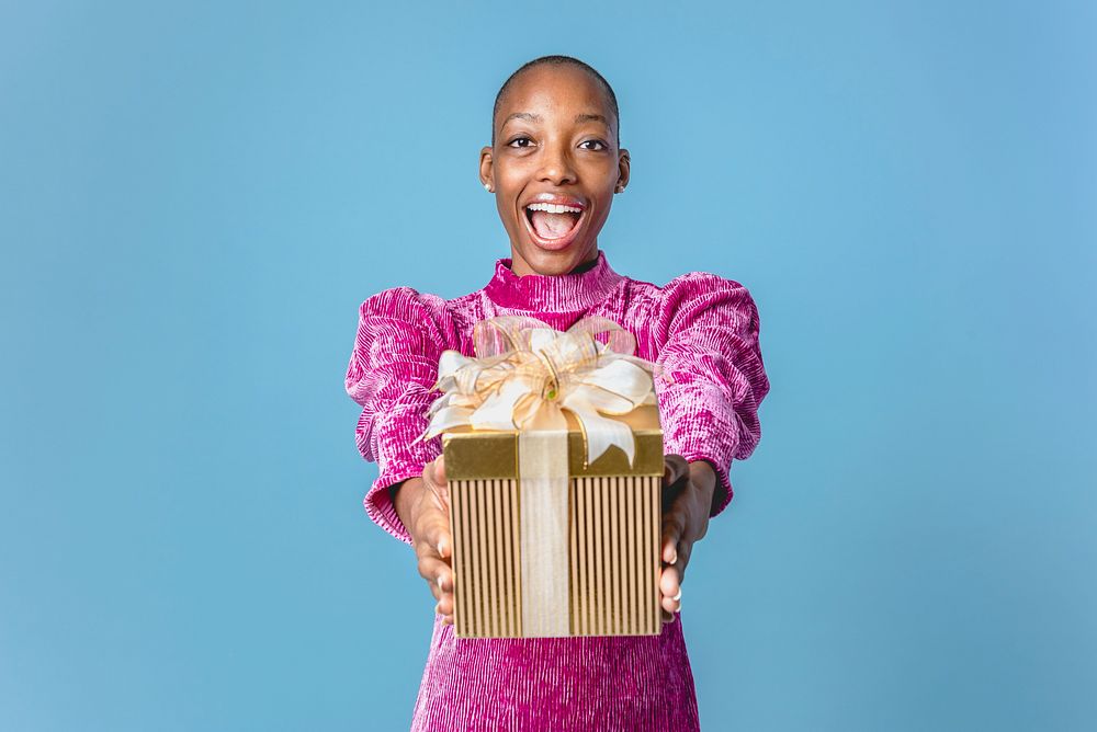 Happy black woman giving a present