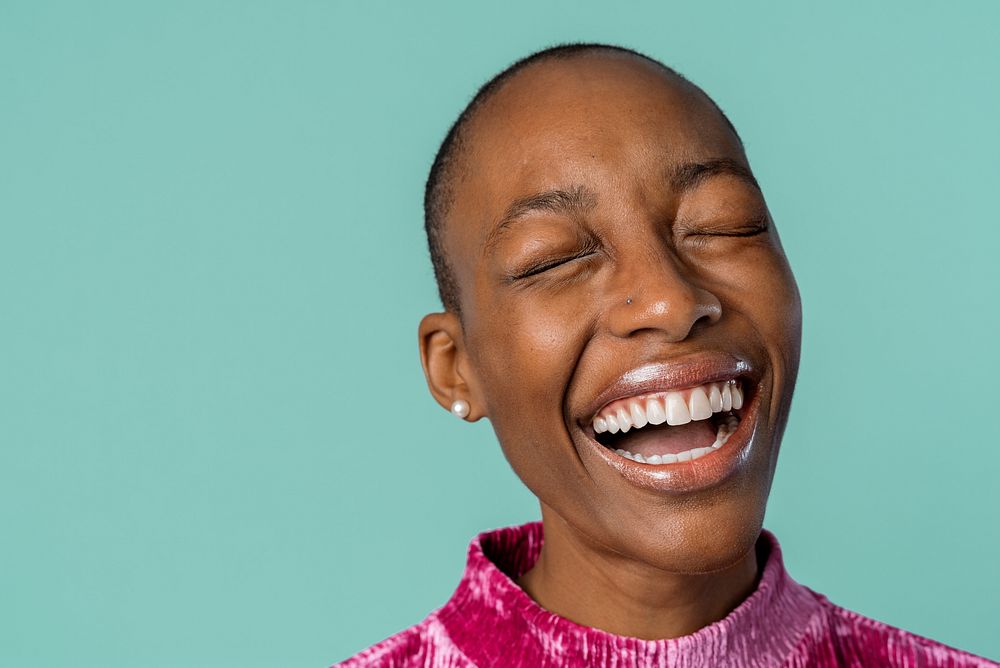 Cheerful black woman against a turquoise background