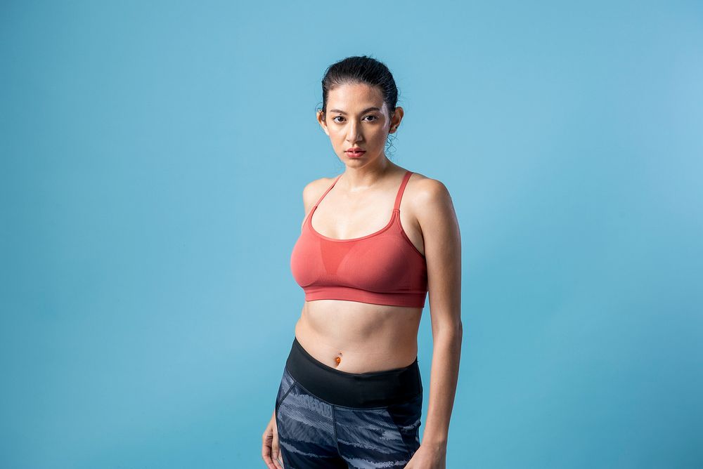 Active Indian woman in sportswear on blue background
