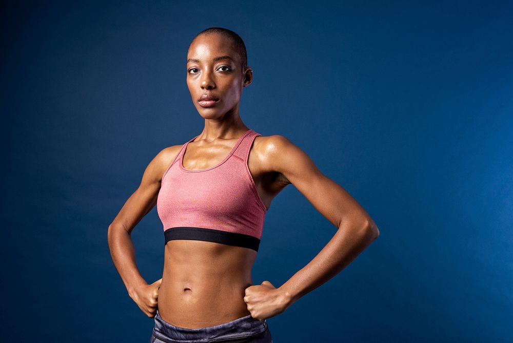 Black woman in sportswear on blue background