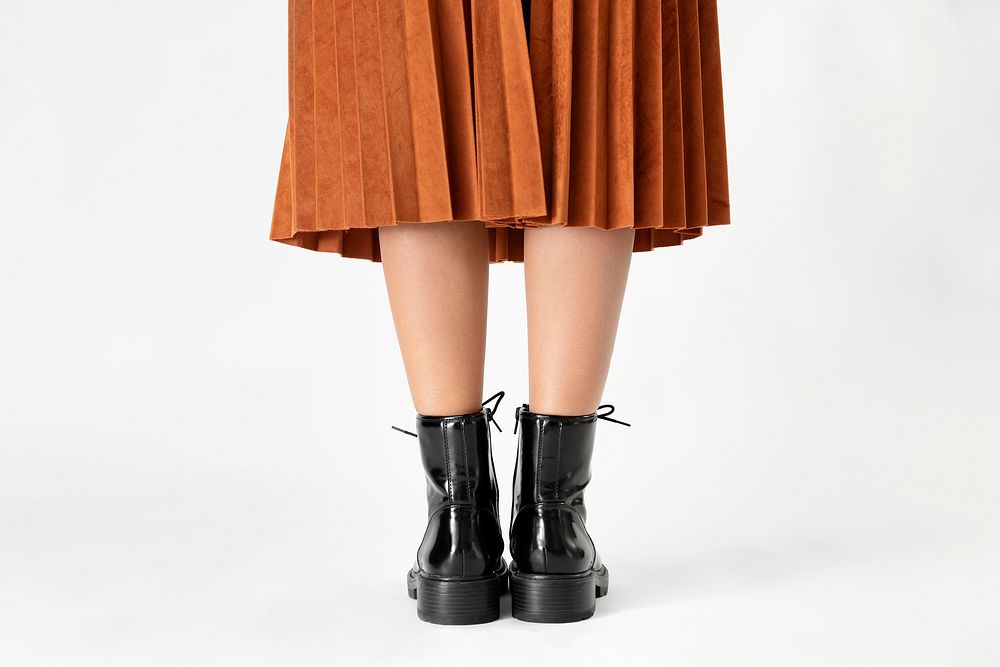 Woman in a skirt wearing combat boots