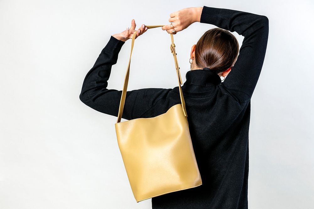 Woman from behind with a brown crossbody bag
